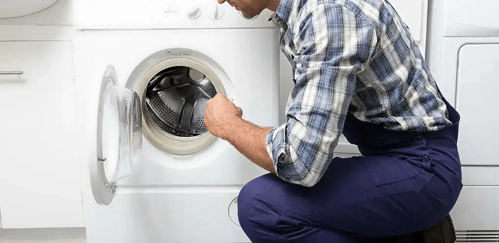 Handyman inspecting a dryer drum and internal parts for repair in Boise, ID