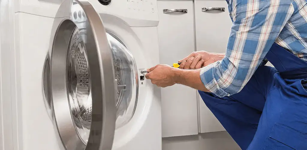 Handyman repairing a clothes dryer and checking electrical connections in Boise, ID