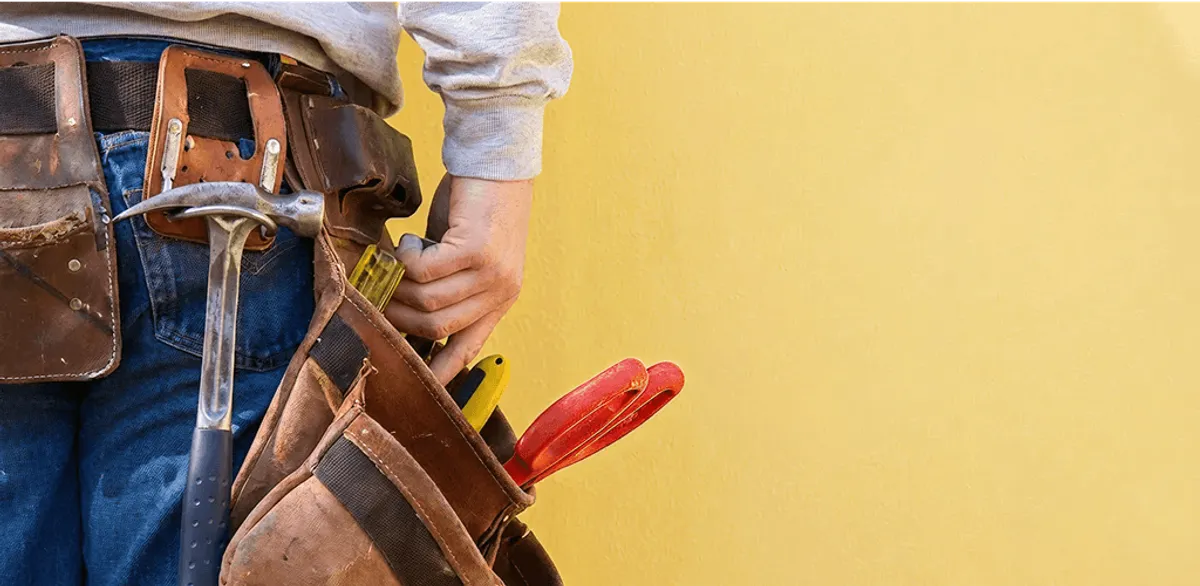 Handyman with tool belt ready for home repairs and maintenance in Boise, ID