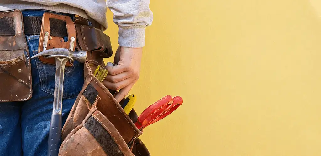 Handyman with tool belt ready for home repairs and maintenance in Boise, ID
