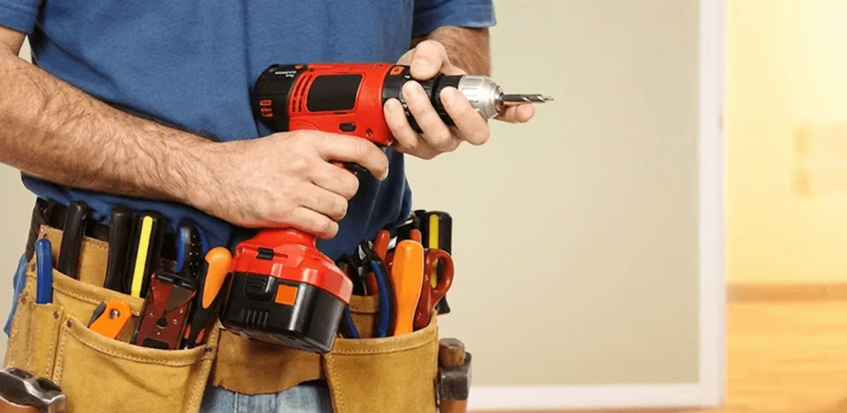 Handyman holding a power drill for home repairs and installations in Boise, ID