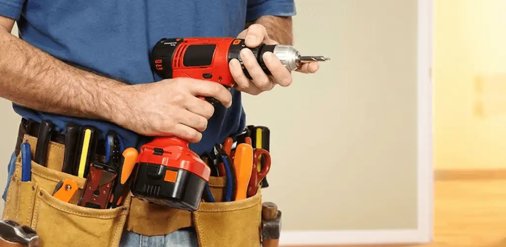 Handyman holding a power drill for home repairs and installations in Boise, ID