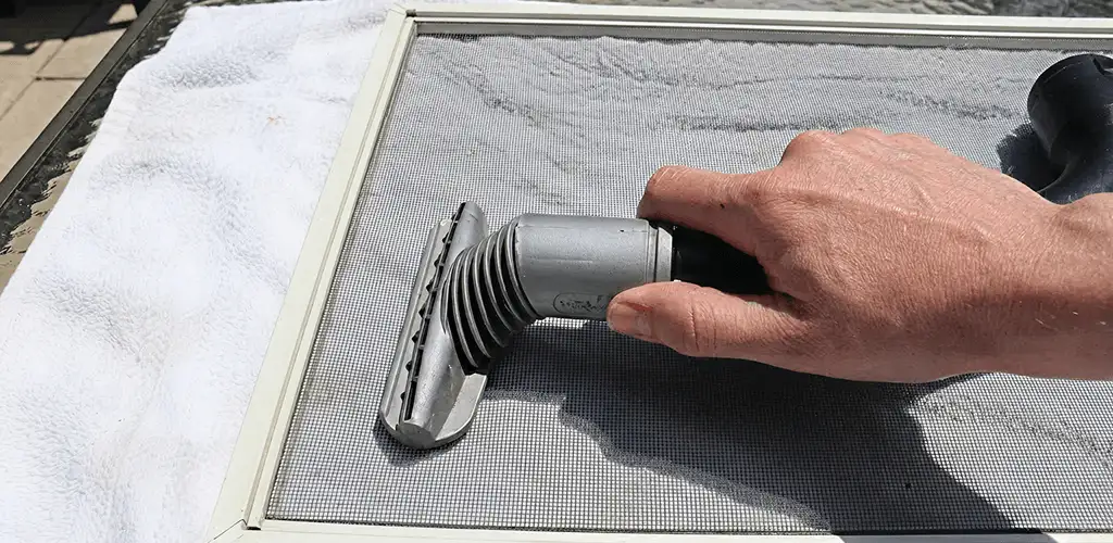 Window screen repair cleaning and fixing a damaged screen mesh in Boise, ID
